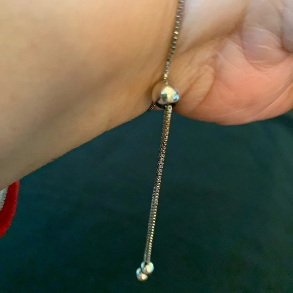 Rhodium over sterling silver lab ruby heart bolo bracelet